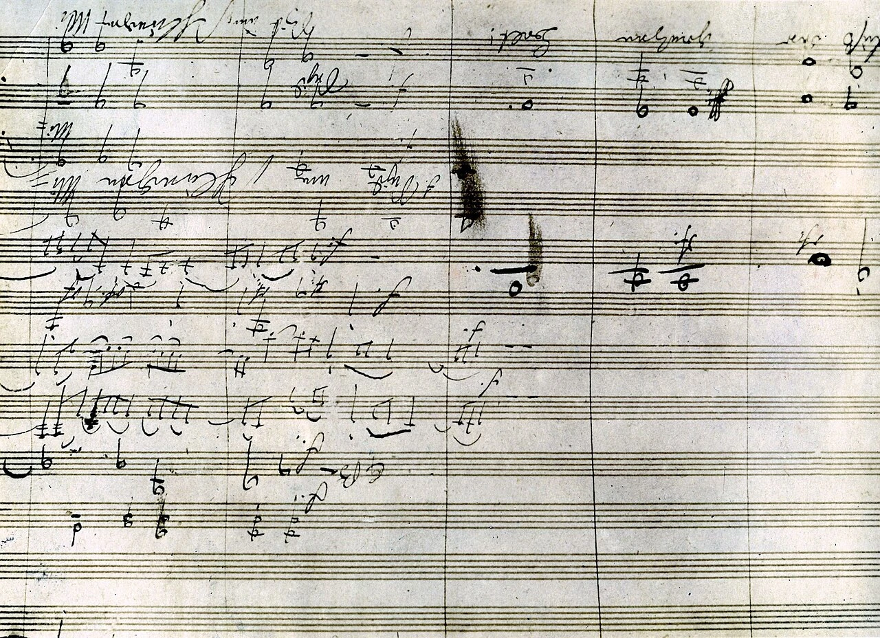 Photograph of a passage from the autograph of the Ninth Symphony, heavily worked, with crossings-out